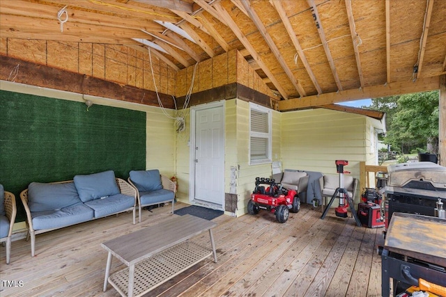 wooden terrace with area for grilling and outdoor lounge area