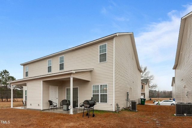 rear view of house featuring a patio and central air condition unit