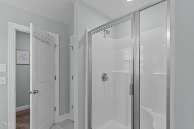 bathroom with a shower with door