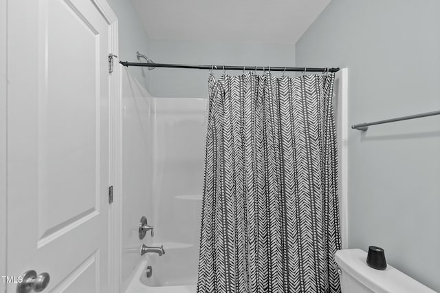 bathroom with shower / bathtub combination with curtain and toilet