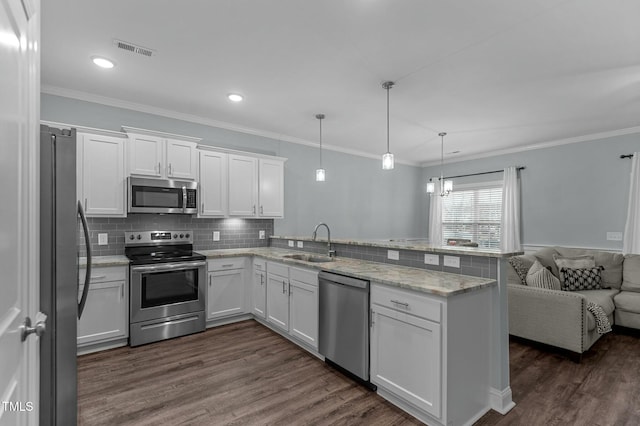 kitchen featuring pendant lighting, white cabinetry, sink, kitchen peninsula, and stainless steel appliances