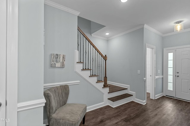 foyer featuring ornamental molding and dark hardwood / wood-style floors