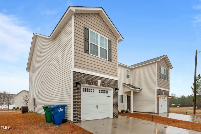 view of front of home featuring central AC unit and a garage