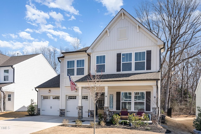 view of front of property with a porch, a garage, concrete driveway, stone siding, and board and batten siding