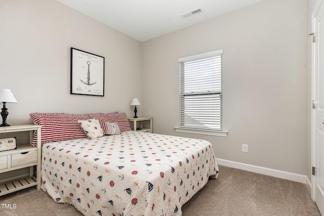 bedroom featuring visible vents, light carpet, and baseboards