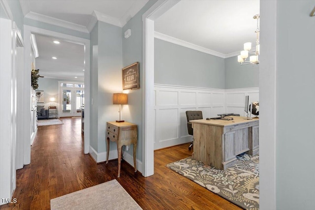 interior space featuring an inviting chandelier, ornamental molding, dark hardwood / wood-style flooring, and french doors