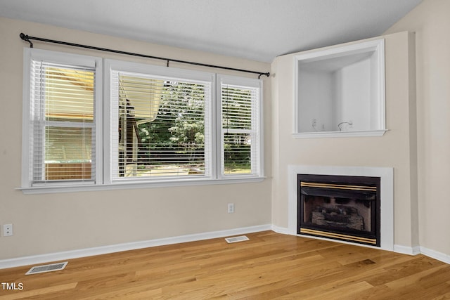 276 Sagamore Dr, Louisburg, NC 27549 - unfurnished living room with visible vents, a fireplace, light wood-style flooring, and baseboards