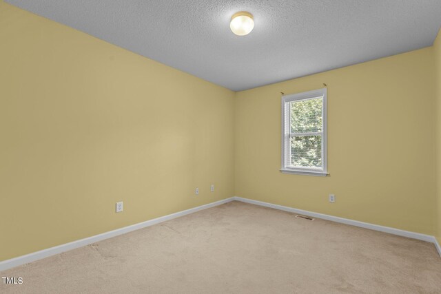 276 Sagamore Dr, Louisburg, NC 27549 - empty room with baseboards, a textured ceiling, visible vents, and light colored carpet