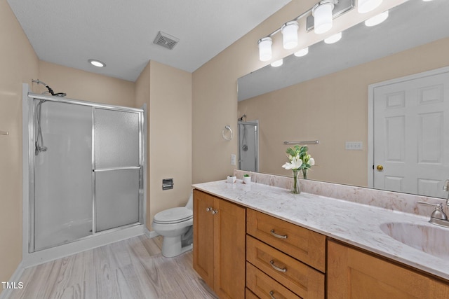 276 Sagamore Dr, Louisburg, NC 27549 - full bath with a stall shower, visible vents, toilet, wood finished floors, and vanity