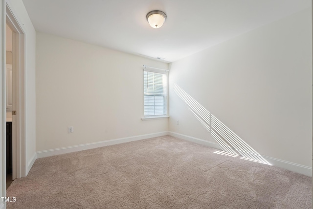 unfurnished room featuring baseboards and carpet flooring