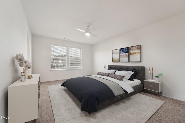 bedroom featuring light colored carpet, ceiling fan, and baseboards