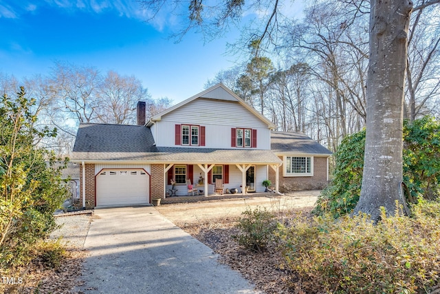 view of property with a garage and a porch