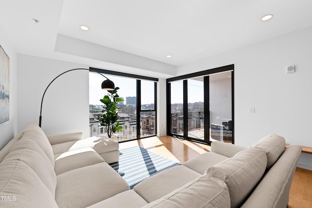 living room featuring recessed lighting, a city view, and light wood finished floors