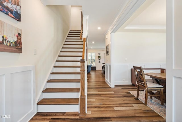 220 Green Haven Blvd, Youngsville, NC 27596 - stairs featuring wainscoting, a decorative wall, recessed lighting, and wood finished floors