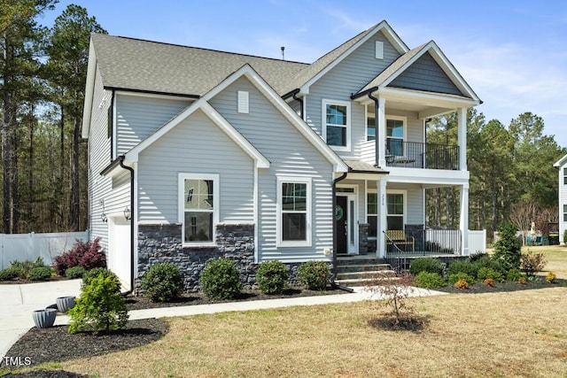 220 Green Haven Blvd, Youngsville, NC 27596 - view of front of house with a balcony, fence, a front lawn, and a porch
