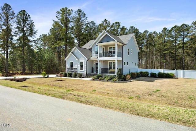 220 Green Haven Blvd, Youngsville, NC 27596 - view of front of property featuring covered porch, a balcony, a front yard, and fence