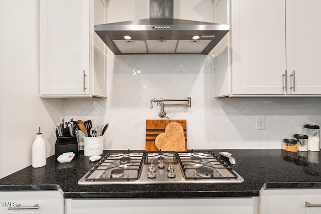 220 Green Haven Blvd, Youngsville, NC 27596 - kitchen featuring white cabinetry, stainless steel gas cooktop, dark stone counters, backsplash, and wall chimney exhaust hood