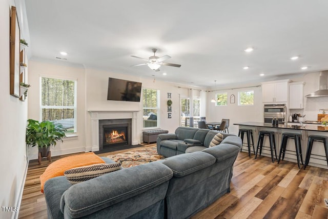 220 Green Haven Blvd, Youngsville, NC 27596 - living room featuring a fireplace with flush hearth, light wood-style floors, ceiling fan, and recessed lighting