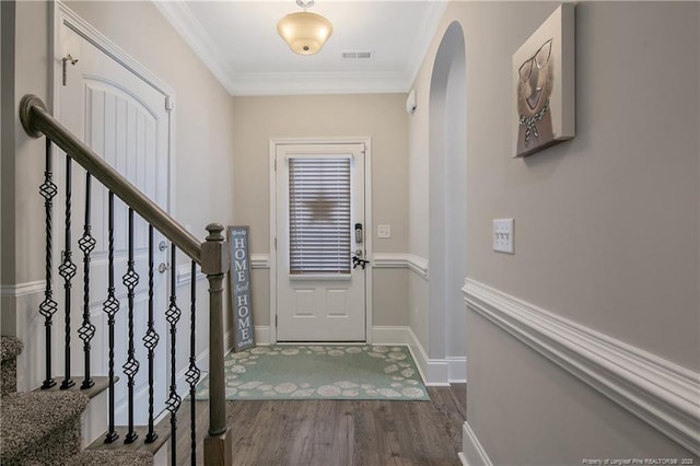 entryway with crown molding and dark hardwood / wood-style flooring