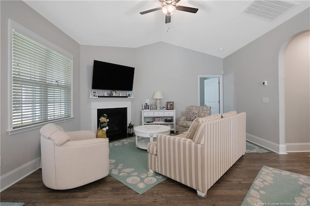 living room with lofted ceiling, dark hardwood / wood-style floors, and ceiling fan