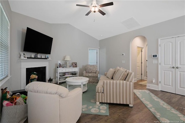 living room featuring vaulted ceiling, dark hardwood / wood-style floors, and ceiling fan