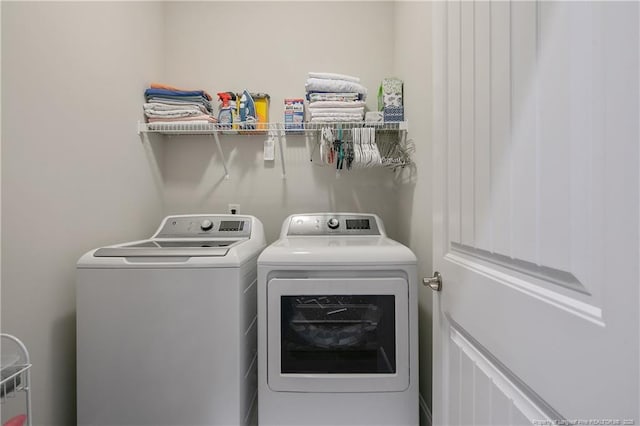 clothes washing area featuring washer and clothes dryer