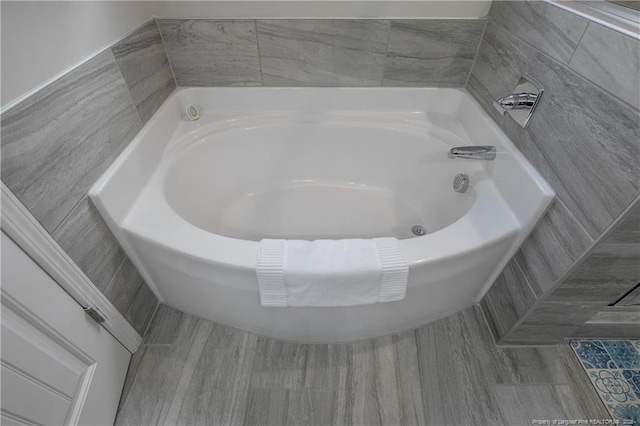 bathroom with a tub to relax in