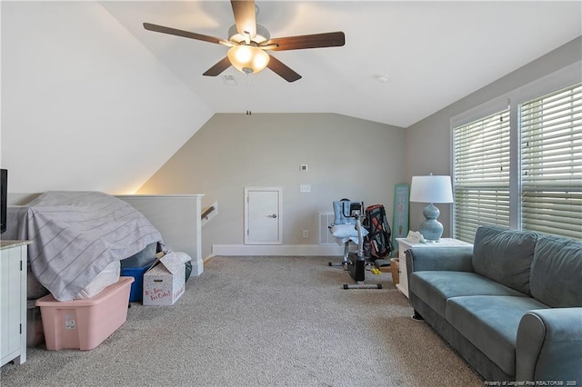 interior space with vaulted ceiling, light carpet, and ceiling fan