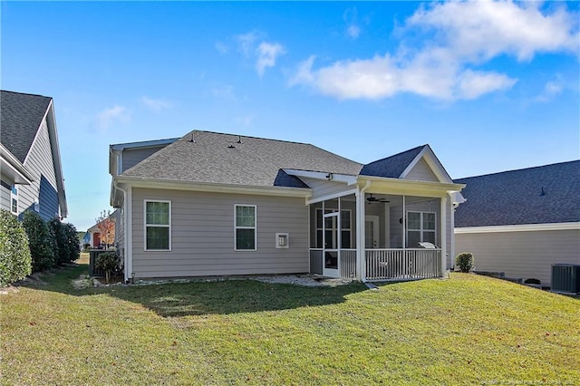 back of house with cooling unit, ceiling fan, a sunroom, and a lawn