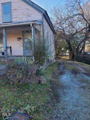 view of side of home with a porch