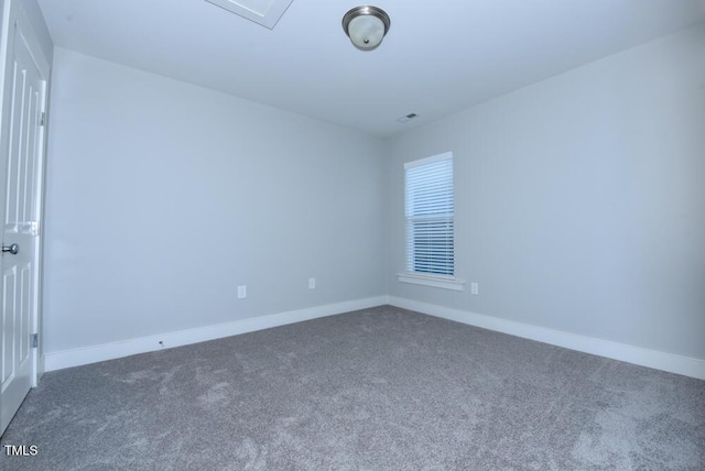 carpeted spare room featuring baseboards