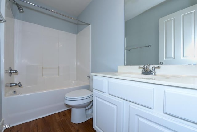 bathroom with toilet, bathtub / shower combination, wood finished floors, and vanity