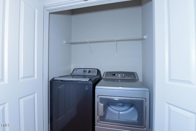 washroom featuring laundry area and washer and clothes dryer