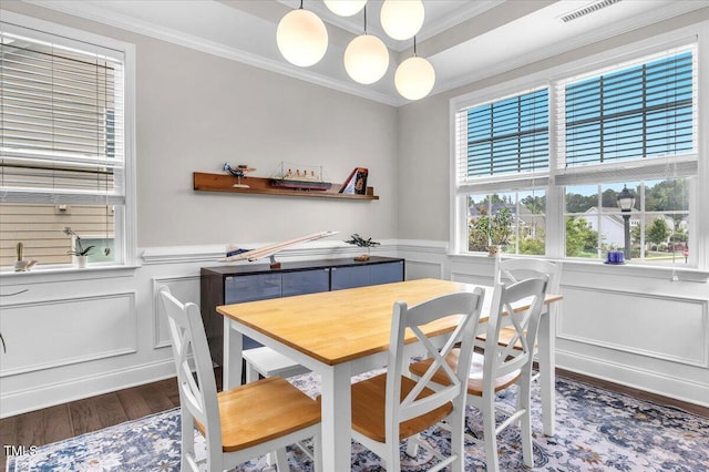 208 Cecelia Ct, Cary, NC 27519 - dining room with wood finished floors, ornamental molding, a decorative wall, and wainscoting