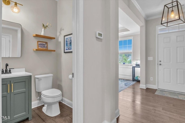 208 Cecelia Ct, Cary, NC 27519 - bathroom featuring crown molding, wood finished floors, toilet, vanity, and baseboards