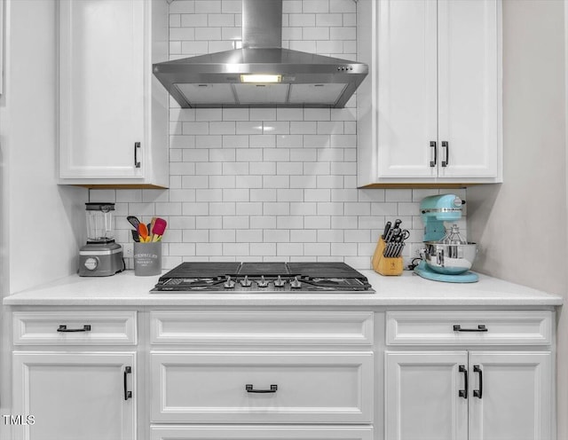 208 Cecelia Ct, Cary, NC 27519 - kitchen featuring wall chimney range hood, white cabinets, stainless steel gas stovetop, tasteful backsplash, and light countertops