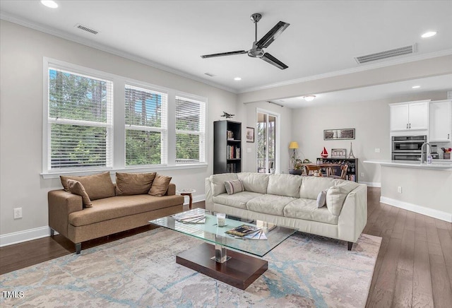 208 Cecelia Ct, Cary, NC 27519 - living room featuring dark wood-style floors, ornamental molding, baseboards, ceiling fan, and recessed lighting