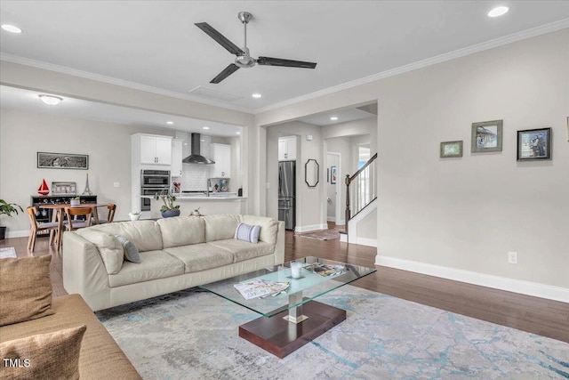 208 Cecelia Ct, Cary, NC 27519 - living area with ceiling fan, baseboards, dark wood-style floors, ornamental molding, and stairway