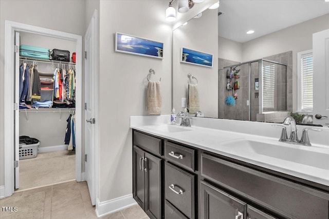 208 Cecelia Ct, Cary, NC 27519 - bathroom with a stall shower, a spacious closet, double vanity, tile patterned floors, and baseboards