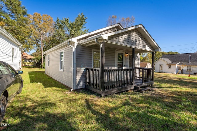 view of front of home featuring covered porch and a front lawn