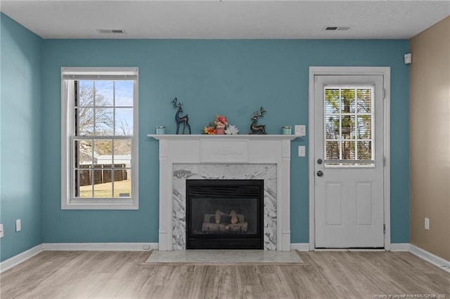 unfurnished living room featuring light hardwood / wood-style flooring and a fireplace