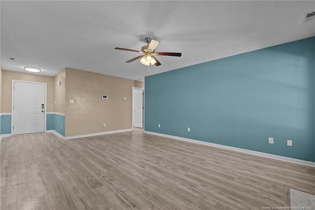 spare room featuring ceiling fan and light hardwood / wood-style floors