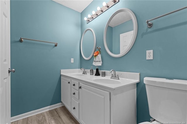 bathroom featuring hardwood / wood-style flooring, vanity, and toilet