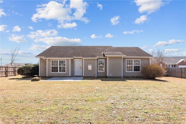 rear view of house with a patio and a lawn