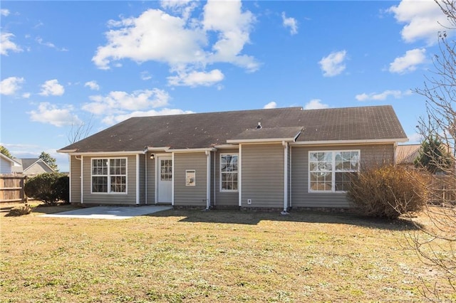 back of property with a patio and a lawn