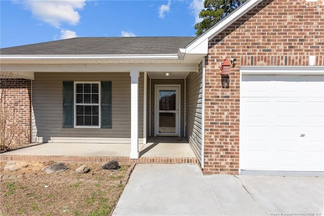 doorway to property with a garage