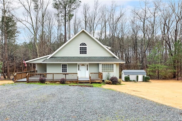 farmhouse-style home featuring a storage shed