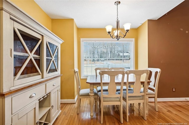 dining room featuring an inviting chandelier and light hardwood / wood-style flooring