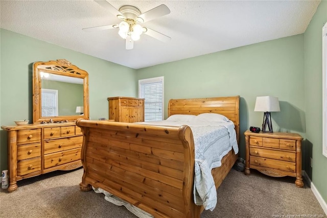 carpeted bedroom featuring a textured ceiling and ceiling fan