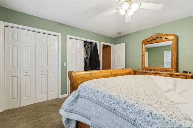 bedroom with multiple closets, ceiling fan, and carpet